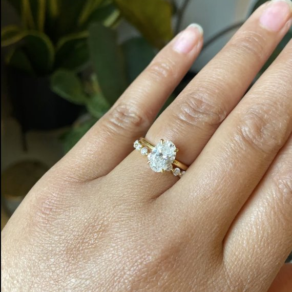 Finished oval lab diamond engagement ring on a customer's hand